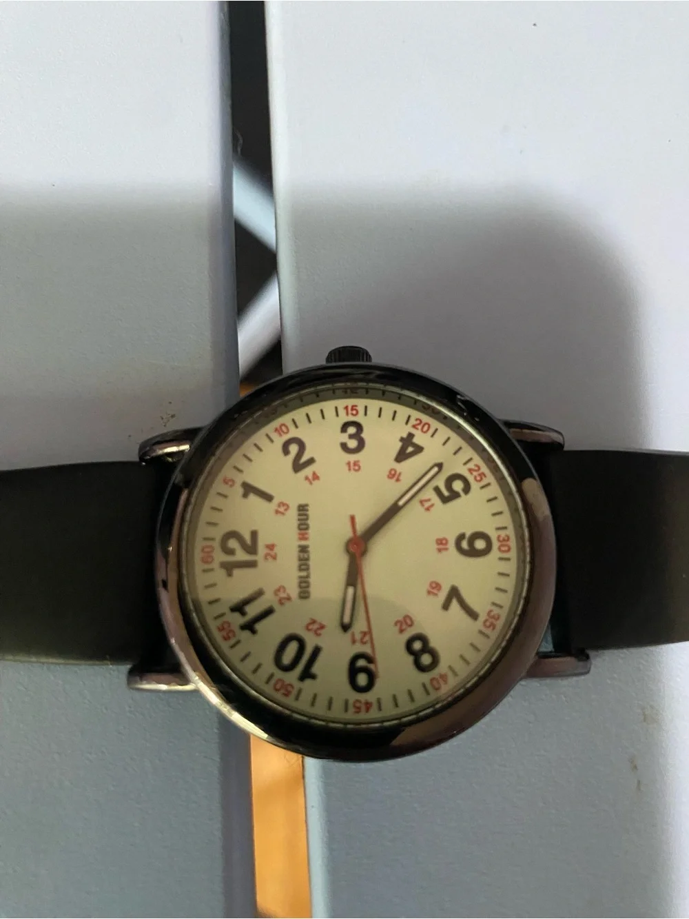 Golden hour Black analog wristwatch with white face and black hands